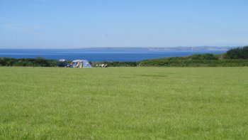 Camp site field coast in background